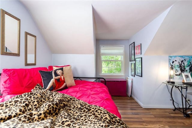 bedroom with dark hardwood / wood-style floors and vaulted ceiling