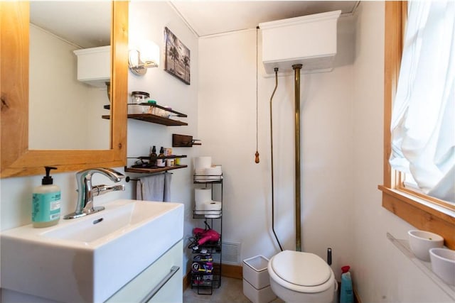 bathroom featuring vanity and toilet