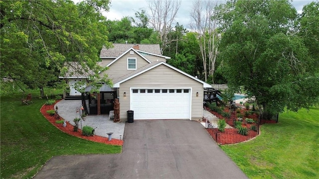 view of front of house featuring a garage and a front lawn