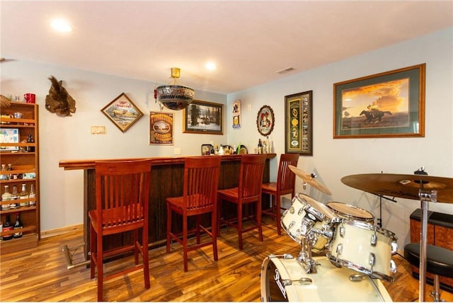 bar with hardwood / wood-style floors