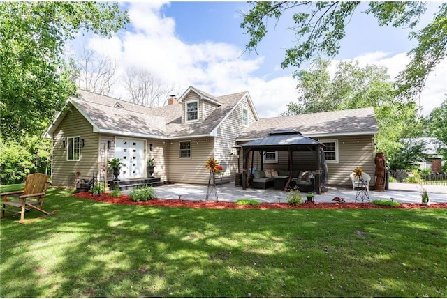 back of house with a gazebo, a patio area, an outdoor hangout area, and a yard