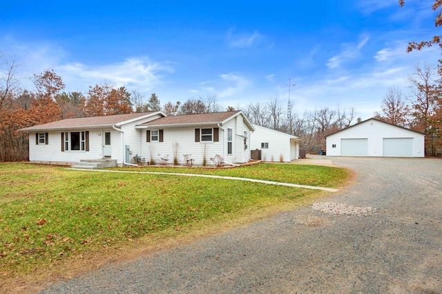 ranch-style house with a garage, an outbuilding, and a front lawn