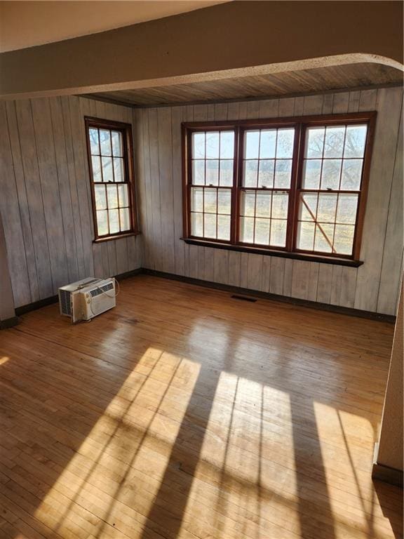 unfurnished room with plenty of natural light and light hardwood / wood-style floors