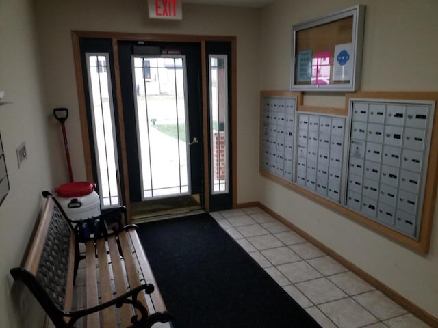 entryway featuring mail boxes and light tile patterned floors