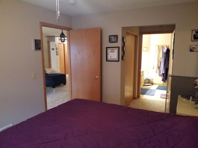 unfurnished bedroom featuring light carpet and a closet