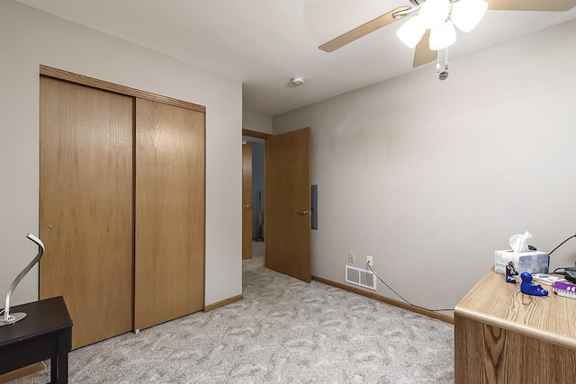 bedroom with light colored carpet, a closet, and ceiling fan