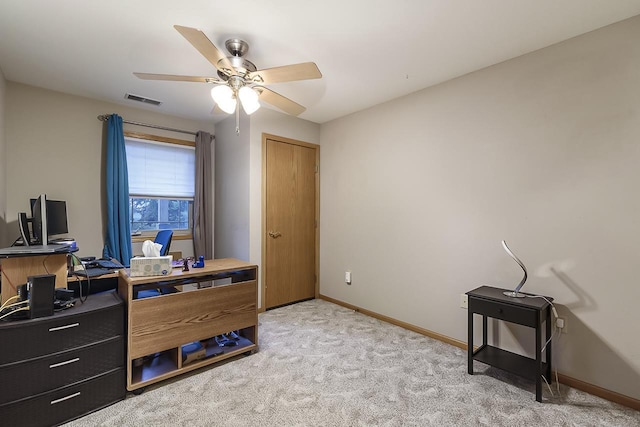 carpeted office space featuring ceiling fan