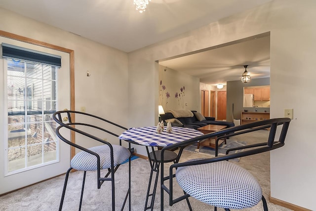 dining room with light colored carpet