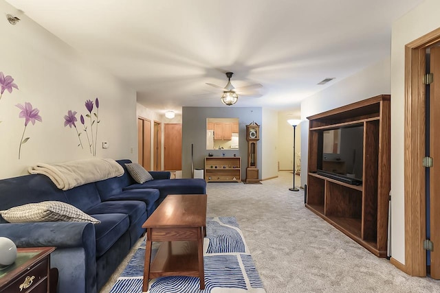 living room featuring light carpet and ceiling fan