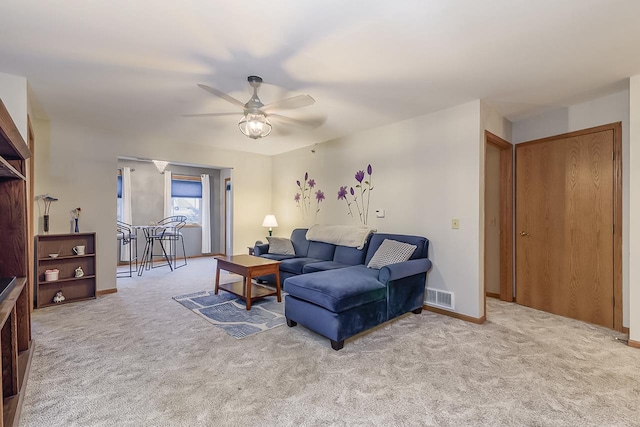 living room with ceiling fan and light carpet