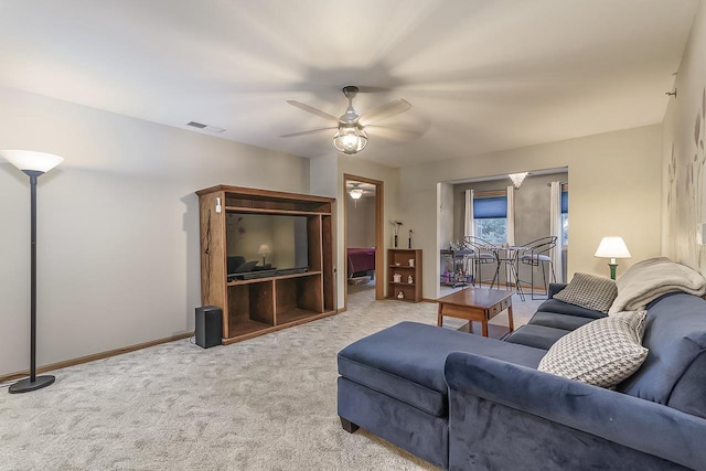 carpeted living room with ceiling fan