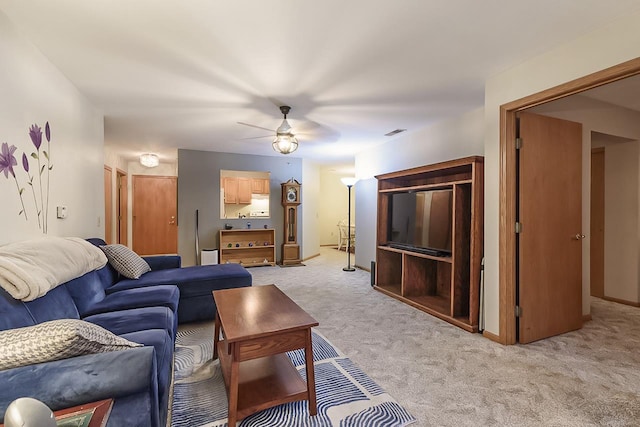 carpeted living room with ceiling fan