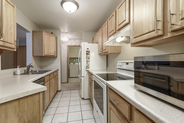 kitchen featuring light brown cabinets, sink, light tile patterned floors, washer / dryer, and stainless steel appliances