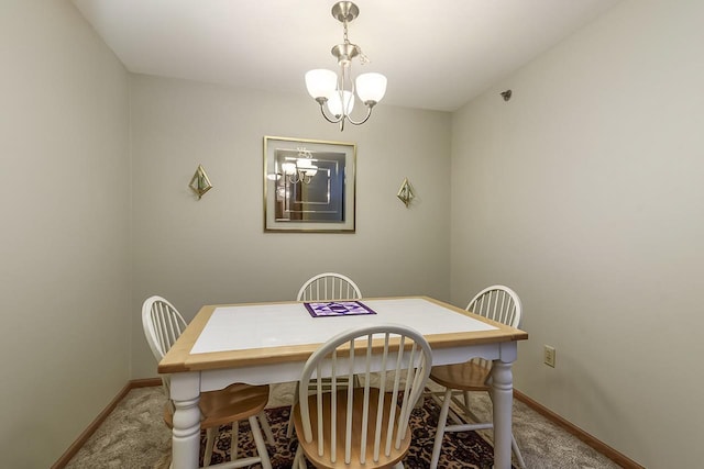 carpeted dining room featuring a notable chandelier