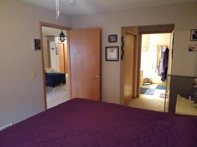 unfurnished bedroom with light colored carpet and a closet