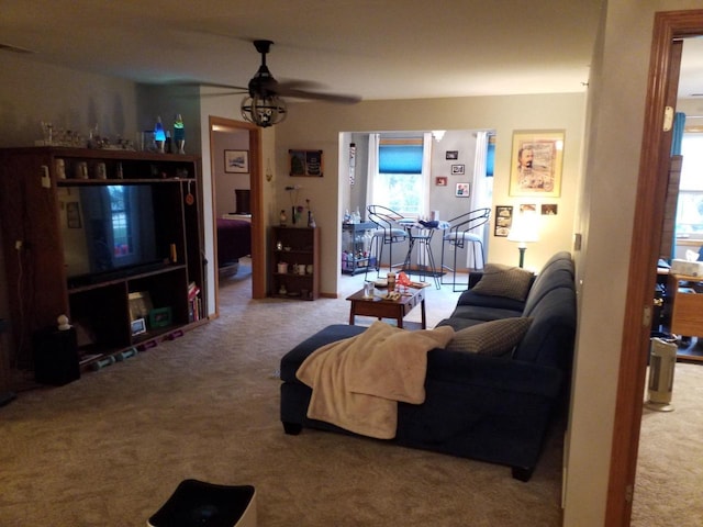 living room featuring carpet flooring and ceiling fan