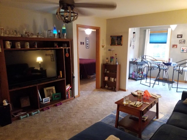 carpeted living room with ceiling fan