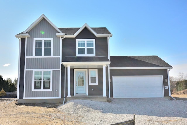 929 5 Mile Rd, Racine, WI 53402 - view of front of property with driveway, a garage, a porch, and board and batten siding