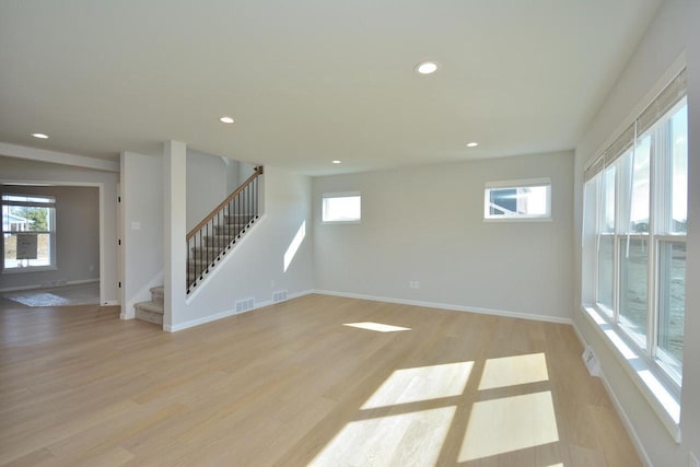 929 5 Mile Rd, Racine, WI 53402 - unfurnished living room featuring recessed lighting, stairs, and light wood-style flooring