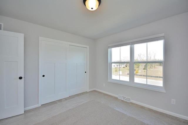 929 5 Mile Rd, Racine, WI 53402 - unfurnished bedroom featuring light colored carpet and a closet