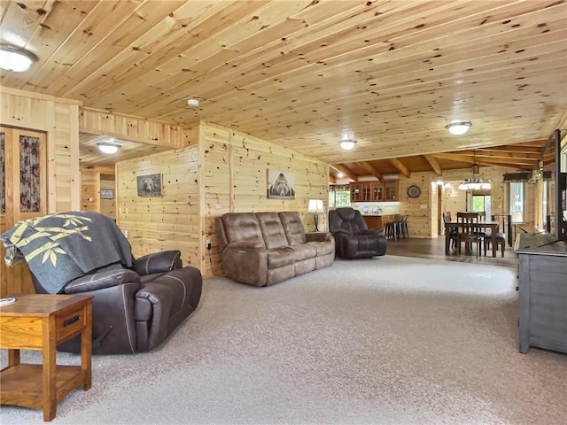 carpeted living room featuring wood ceiling, wood walls, and a healthy amount of sunlight