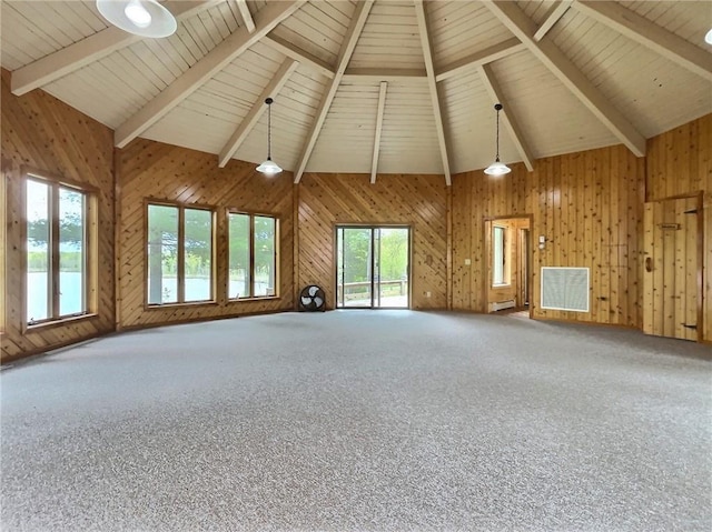 unfurnished living room with wood walls, wooden ceiling, high vaulted ceiling, carpet flooring, and beam ceiling