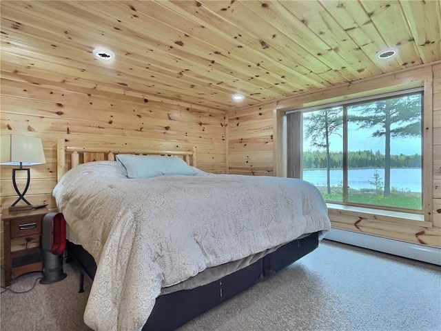 carpeted bedroom with wood walls, a water view, and wood ceiling