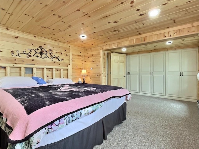 carpeted bedroom featuring wooden ceiling and wooden walls