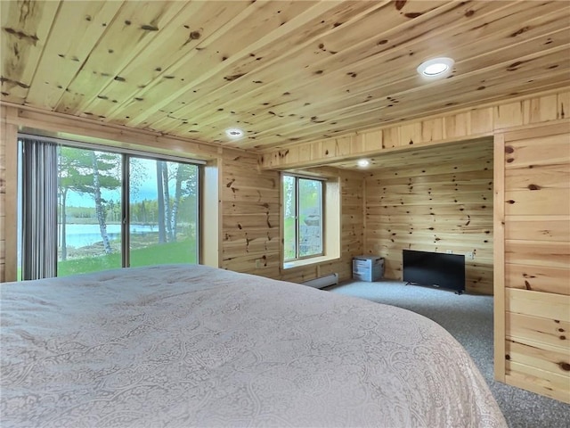 carpeted bedroom with access to exterior, wood walls, a water view, and wood ceiling