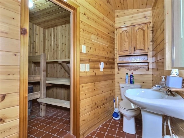 bathroom featuring tile patterned flooring, wooden ceiling, and wood walls