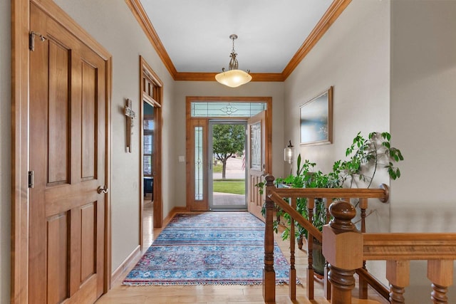 foyer featuring light wood-type flooring and crown molding