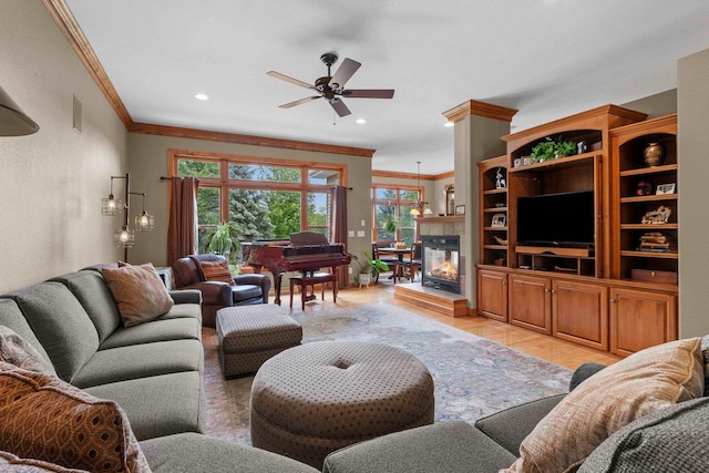 217 Hidden Ridges Way, Combined Locks, WI 54113 - living room with crown molding, ceiling fan, light wood finished floors, a tiled fireplace, and recessed lighting