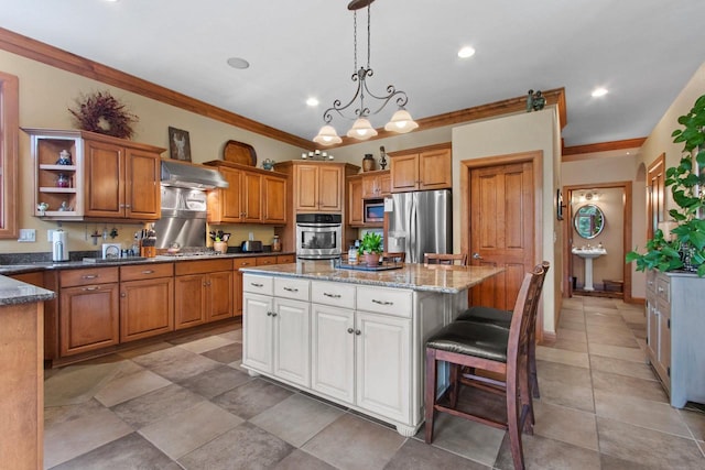 217 Hidden Ridges Way, Combined Locks, WI 54113 - kitchen with appliances with stainless steel finishes, ornamental molding, a kitchen island, brown cabinets, and wall chimney range hood