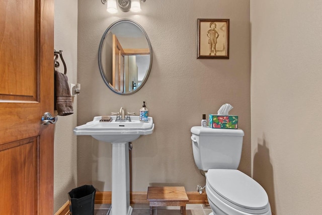 bathroom with tile patterned floors, sink, and toilet