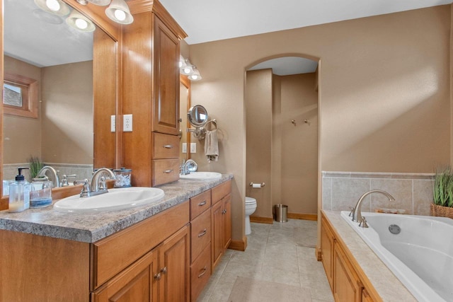 217 Hidden Ridges Way, Combined Locks, WI 54113 - bathroom with vanity, a garden tub, toilet, and tile patterned flooring