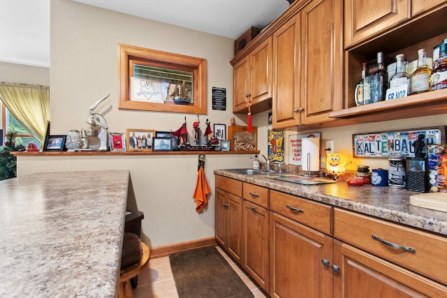 217 Hidden Ridges Way, Combined Locks, WI 54113 - kitchen with a sink, brown cabinets, and baseboards