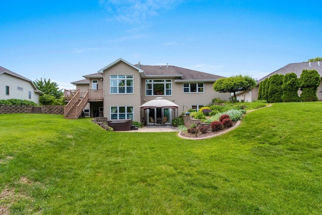 rear view of house featuring a gazebo, a deck, and a yard