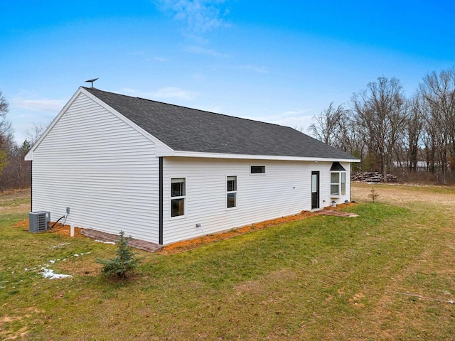 view of property exterior featuring a lawn and central AC unit