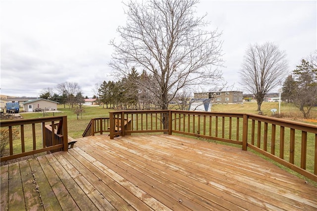 wooden deck featuring a lawn