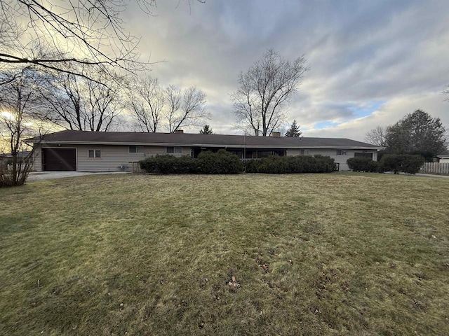 637 N Wright Rd, Janesville, WI 53546 - back of house featuring a yard and an attached garage
