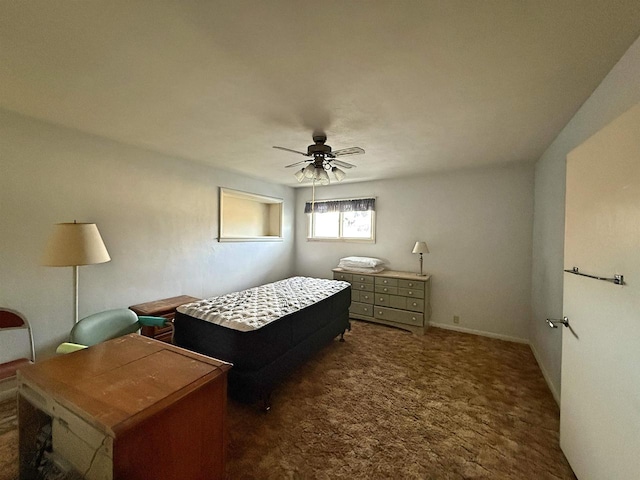 bedroom featuring ceiling fan and dark colored carpet