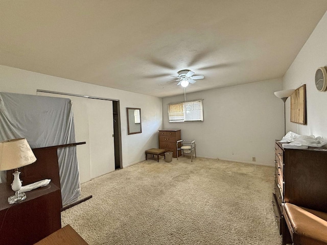 sitting room featuring light colored carpet and ceiling fan