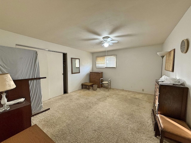 sitting room with ceiling fan and light colored carpet