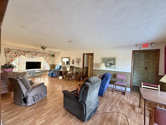 637 N Wright Rd, Janesville, WI 53546 - living area featuring a textured ceiling, wood finished floors, and a ceiling fan