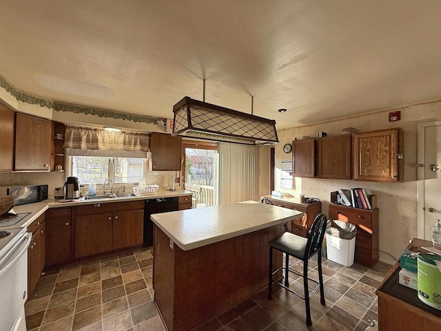 637 N Wright Rd, Janesville, WI 53546 - kitchen with black dishwasher, electric range, a center island, light countertops, and a kitchen bar