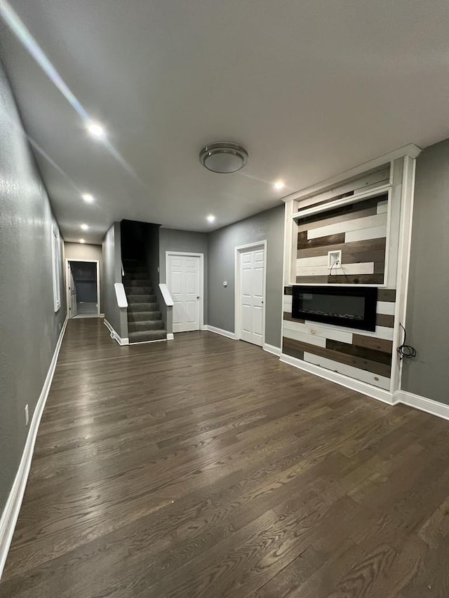 unfurnished living room with dark hardwood / wood-style floors