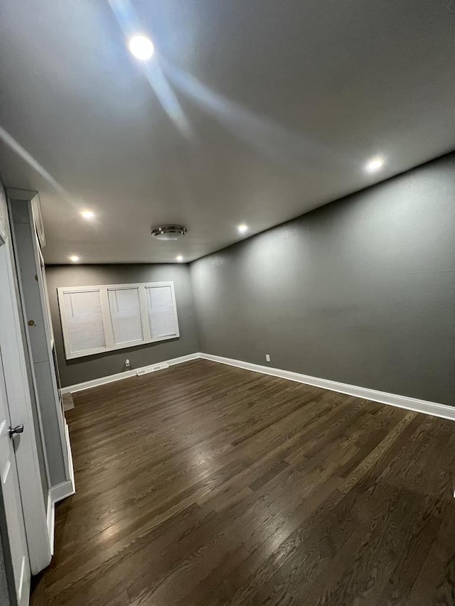 spare room with dark wood-type flooring