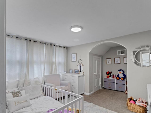 carpeted bedroom featuring lofted ceiling