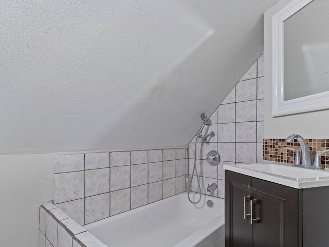 bathroom with vanity and a tub