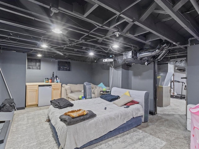 carpeted bedroom with white fridge